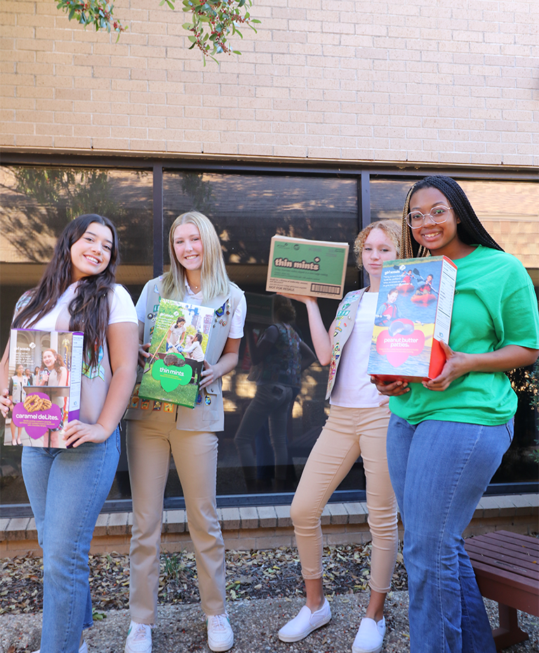 Girl Scouts with cookie boxes